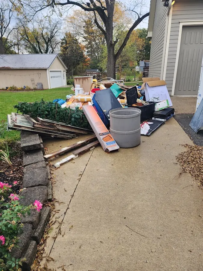 Dumpster being loaded with debris for 12 Yard Dumpster Rental in Bremen